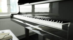 Picture of a polished piano sat ready to be played